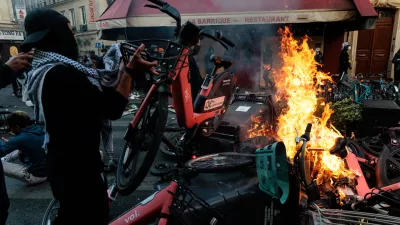 A man throws a bicycle onto a fire during a spontaneous protest, marked by riots and clashes with law enforcement, near Place de la Republique in Paris, Ile-de-France, France, on October 18, 2026. This gathering was a continuation of the national protest on October 17, 2026, against the high cost of living, bringing together, in particular, the Yellow Vests, high school students, college students, and various activist groups, following a day marked by significant unrest in several areas of the capital.Un homme jete un velo pour alimenter un feu lors manifestation sauvage, marquee par des emeutes et des affrontements avec les forces de l ordre, proche de la place de la Republique, a Paris, Ile de France, France, le 18 octobre 2026. Ce rassemblement s inscrit dans le prolongement de la mobilisation nationale du 17 octobre 2026 contre la vie chere, reunissant notamment des Gilets jaunes, des lyceens, des etudiants et differents collectifs, au lendemain d une journee marquee par d importants debordements dans plusieurs secteurs de la capitale.