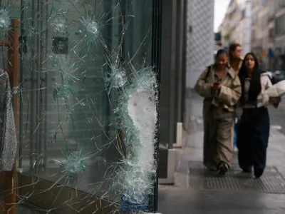 Damaged glass at the Lacoste store on Champs-Elysees avenue, the day after clashes during a national day of demonstrations against the cost of living and rising fuel prices, in Paris, France, October 18, 2026. REUTERS/Stephanie Lecocq