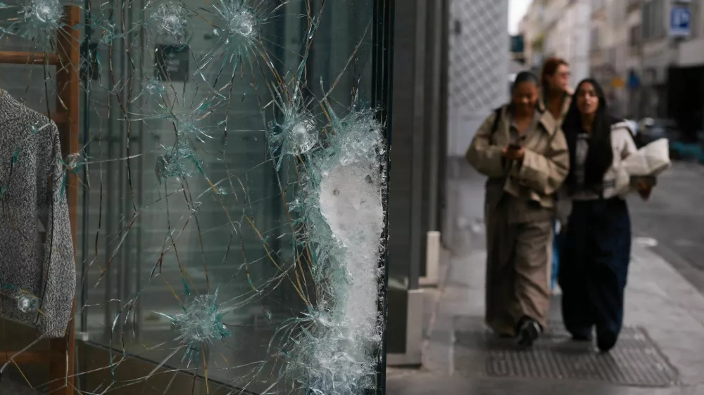 Damaged glass at the Lacoste store on Champs-Elysees avenue, the day after clashes during a national day of demonstrations against the cost of living and rising fuel prices, in Paris, France, October 18, 2026. REUTERS/Stephanie Lecocq