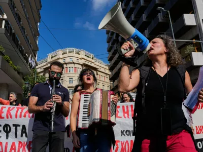 Protesters take part in a rally organized by teachers and students demanding improvements to education and measures to address the rising cost of living in Athens, Greece, Wednesday, Oct. 21, 2026. (AP Photo/Thanassis Stavrakis) CORRECTION: corrects byline to Thanassis Stavrakis instead of Petros Giannakouris