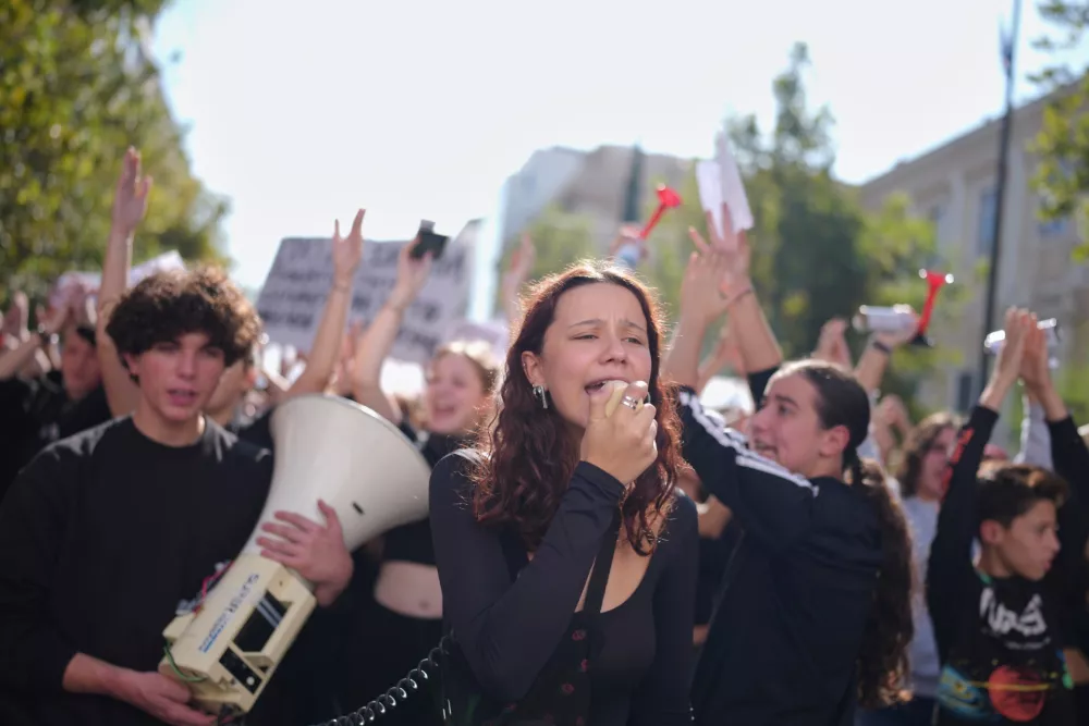 Protesters take part in a rally organized by teachers and students demanding improvements in education and measures to address the rising cost of living in Athens, Greece, Wednesday, Oct. 21, 2026. (AP Photo/Petros Giannakouris)