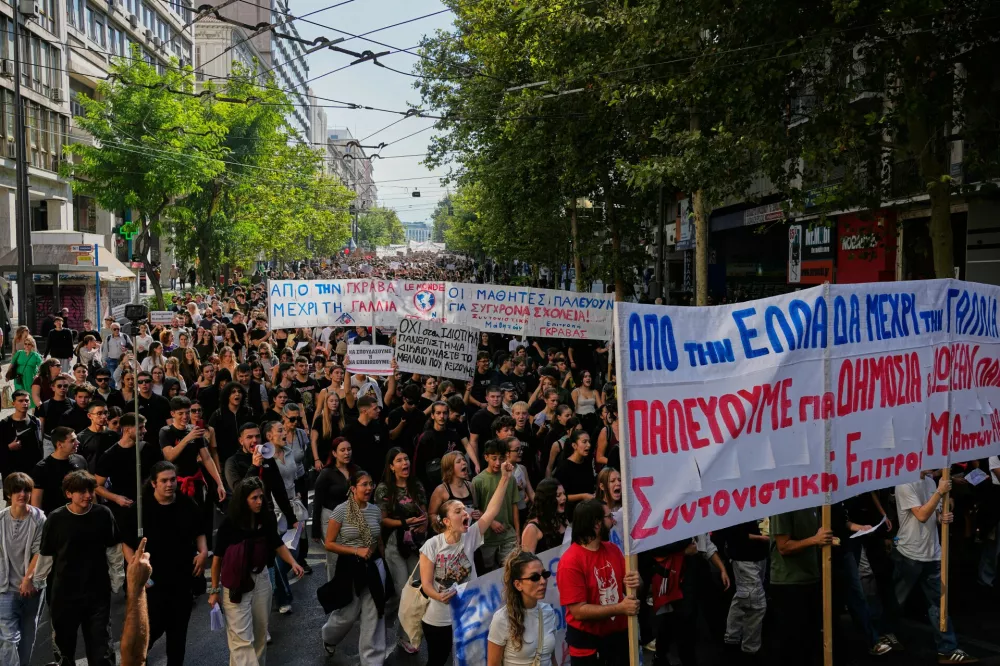 Protesters take part in a rally organized by teachers and students demanding improvements to education and measures to address the rising cost of living in Athens, Greece, Wednesday, Oct. 21, 2026. (AP Photo/Thanassis Stavrakis)