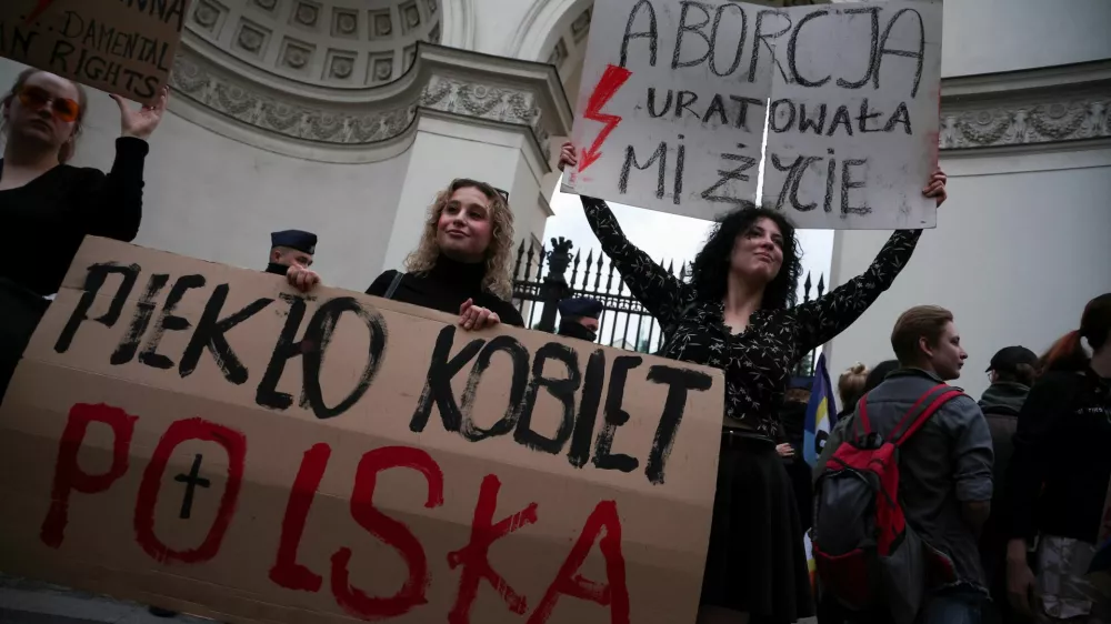 People hold signs that read: "Women's Hell. Poland" and "Abortion saved my life" during a protest, after a pregnant woman died in hospital in an incident campaigners say is the fault of Poland's laws on abortion, which are some of the most restrictive in Europe, in Warsaw, Poland June 14, 2023. REUTERS/Kacper Pempel