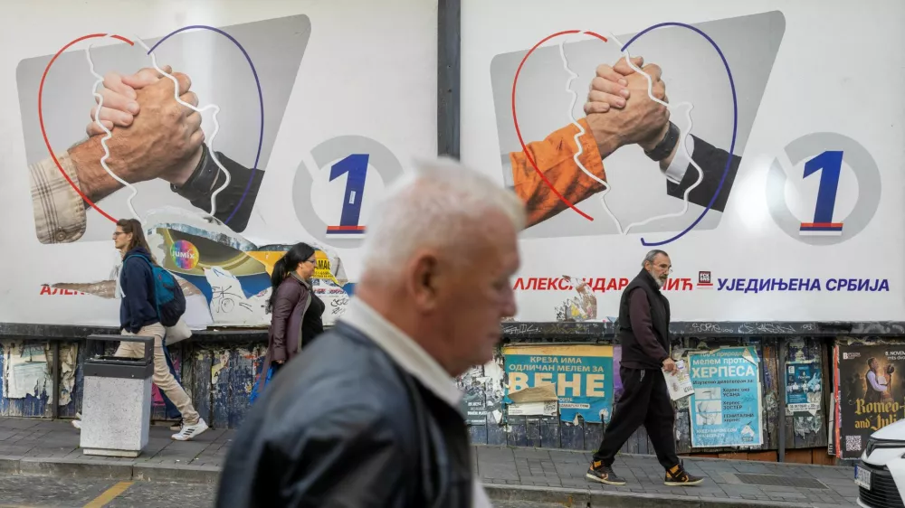 People walk past electoral posters of the Serbian Progressive Party (SNS) in Belgrade, Serbia, October 16, 2026. REUTERS/Djordje Kojadinovic