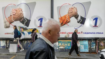 People walk past electoral posters of the Serbian Progressive Party (SNS) in Belgrade, Serbia, October 16, 2026. REUTERS/Djordje Kojadinovic