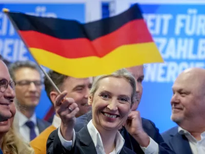 Leader of far right AfD Alice Weidel waves a German flag at the AfD party headquarters in Berlin, Germany, Sunday, Feb. 23, 2025, after the German national election. (AP Photo/Michael Probst)