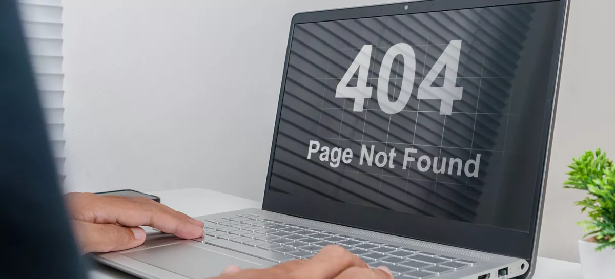 A man working on a laptop with website Page Not Found Error 404 on screen