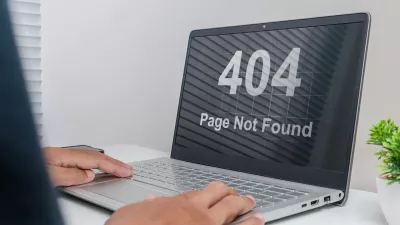 A man working on a laptop with website Page Not Found Error 404 on screen