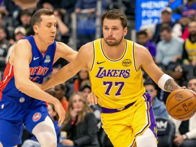 Mar 23, 2026; Detroit, Michigan, USA; Detroit Pistons Duncan Robinson (55) defends against Los Angeles Lakers Luka Doncic (77) during the first quarter at Little Caesars Arena. Mandatory Credit: David Reginek-Imagn Images
