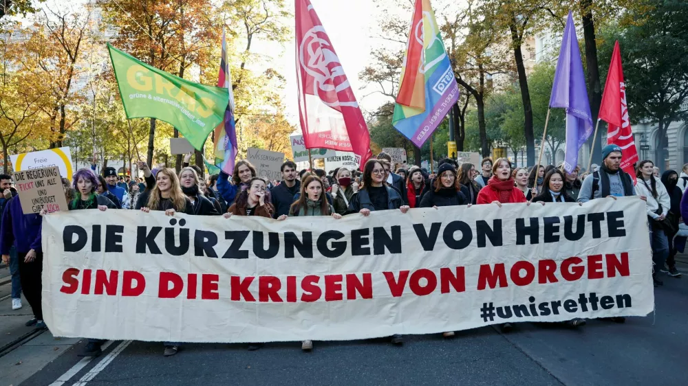 Students hold a banner reading "Today's cuts are tomorrow's crises" as they participate in a protest against the government's cost-cutting for universities, in Vienna, Austria, October 22, 2026. REUTERS/Lisa Leutner