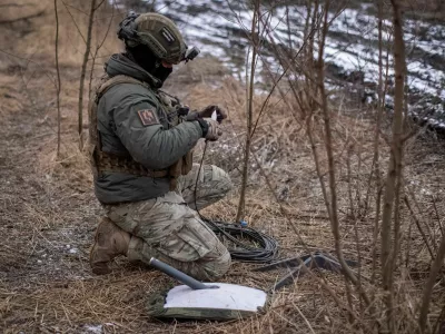 FILE PHOTO: A Ukrainian serviceman of 47th brigade prepares a Starlink satellite internet systems at his positions at a front line, amid Russia's attack on Ukraine, near the town of Avdiivka, recently captured by Russian troops in Donetsk region, Ukraine February 20, 2024. REUTERS/Inna Varenytsia/File Photo