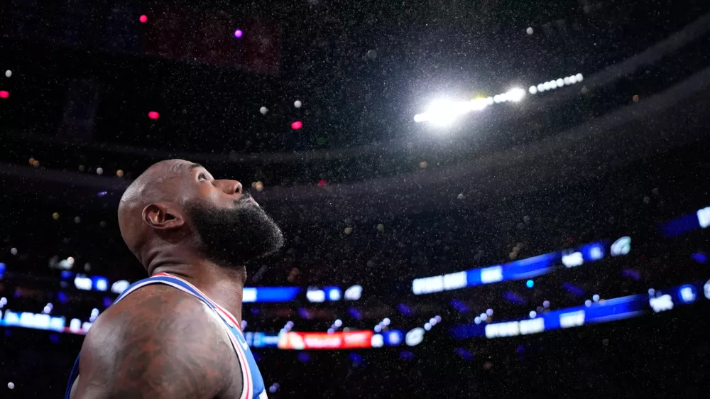 Philadelphia 76ers' LeBron James tosses chalk into the air before an NBA basketball game against the Cleveland Cavaliers Thursday, Oct. 22, 2026, in Philadelphia. (AP Photo/Matt Slocum)