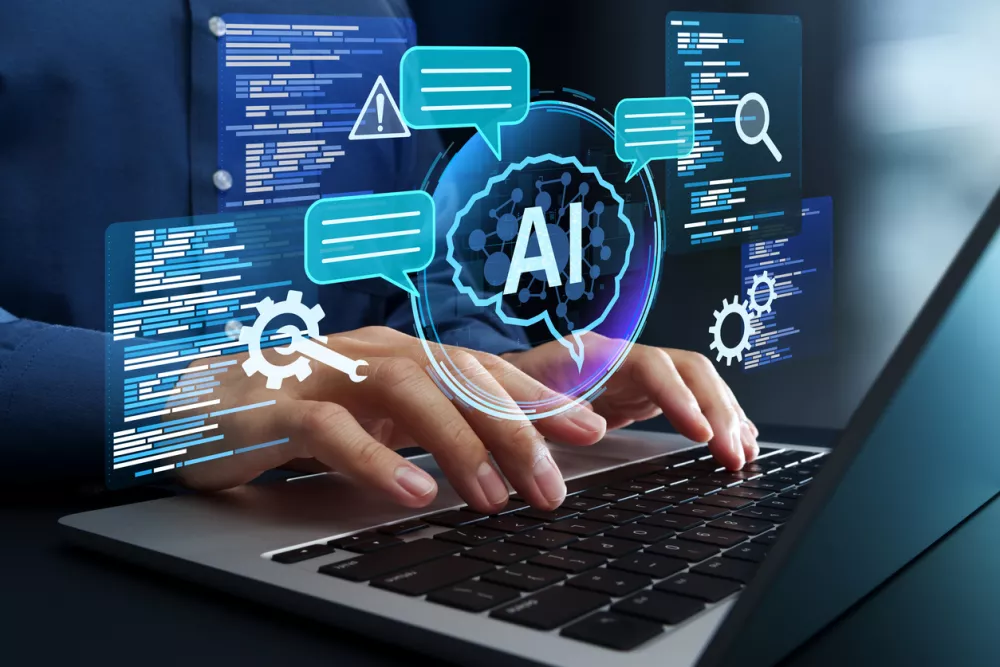 Programmer using AI to generate code for creating applications on laptop.