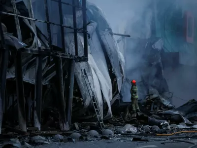 A rescuer works at the site of a shopping centre hit by a Russian missile attack, amid Russia's attack on Ukraine, in Kyiv, Ukraine October 22, 2026. REUTERS/Gleb Garanich