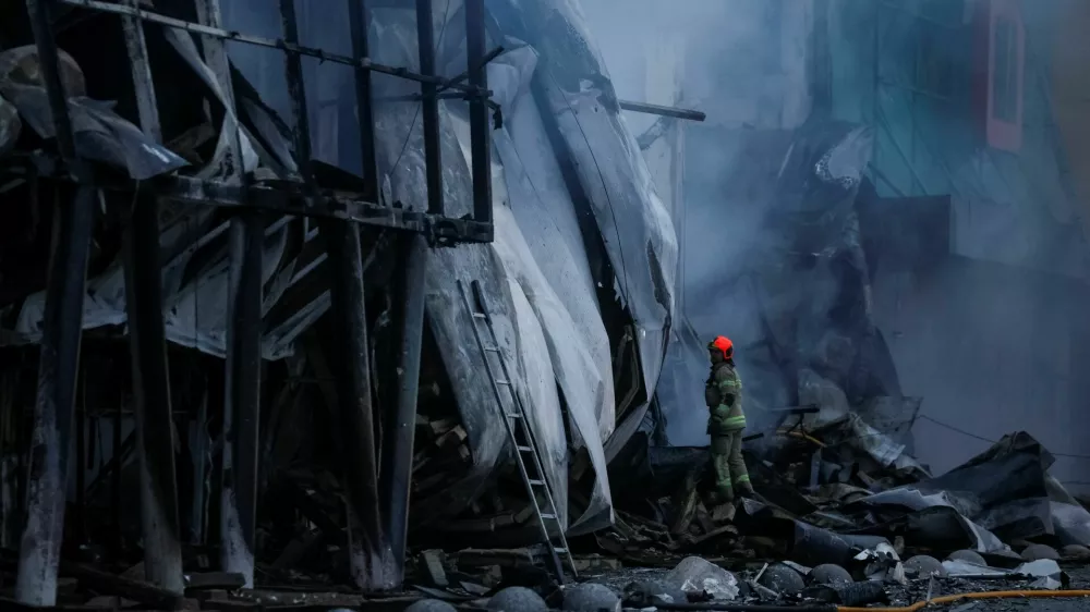 A rescuer works at the site of a shopping centre hit by a Russian missile attack, amid Russia's attack on Ukraine, in Kyiv, Ukraine October 22, 2026. REUTERS/Gleb Garanich