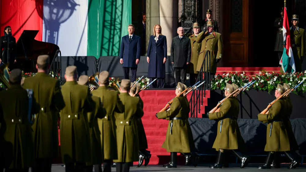 From left, Hungarian Prime Minister Peter Magyar, Agnes Forsthoffer, the Speaker of the National Assembly of Hungary and Hungary's President Andras Baka attend a flag-raising ceremony marking the 70th anniversary of the 1956 Hungarian Revolution against Soviet-backed communist rule in Budapest, Hungary, Friday, Oct. 23, 2026. (AP Photo/Pavel Bogolepov)