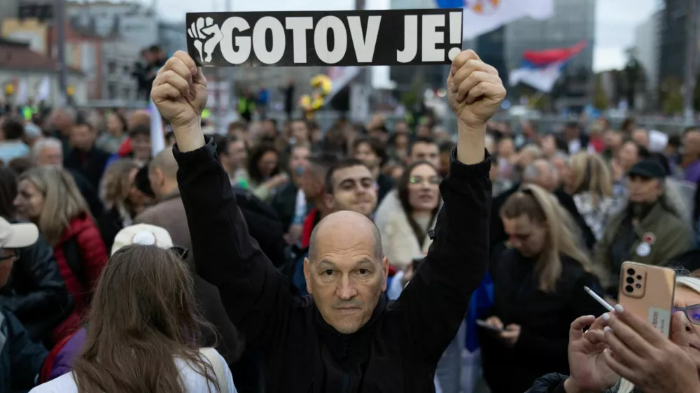 A supporter of the electoral list "Student List - Students Win" holds a sign reading "He is Finished!" referring to former Serbia's President Aleksandar Vucic during a final campaign rally at Slavija Square in Belgrade, Serbia, October 22, 2026. REUTERS/Uros Arsic