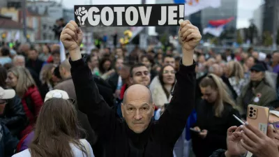 A supporter of the electoral list "Student List - Students Win" holds a sign reading "He is Finished!" referring to former Serbia's President Aleksandar Vucic during a final campaign rally at Slavija Square in Belgrade, Serbia, October 22, 2026. REUTERS/Uros Arsic