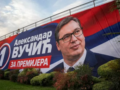 People walk on a bridge with a huge poster of Serbia's former President and the ruling Serbian Progressive Party (SNS) candidate for prime minister Aleksandar Vucic on it, in Nis, Serbia, October 10, 2026. REUTERS/Marko Djurica