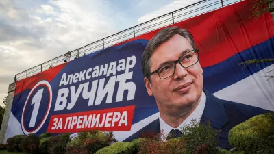 People walk on a bridge with a huge poster of Serbia's former President and the ruling Serbian Progressive Party (SNS) candidate for prime minister Aleksandar Vucic on it, in Nis, Serbia, October 10, 2026. REUTERS/Marko Djurica