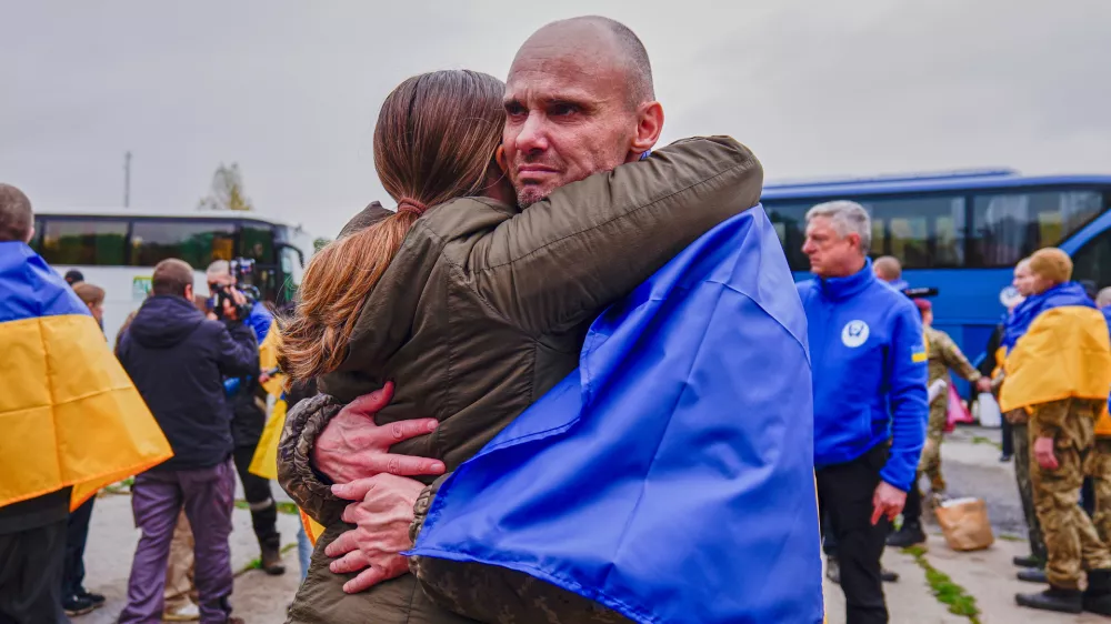 A Ukrainian soldier is welcomed after returning from captivity after a Prisoners of War (POWs) exchange between Russia and Ukraine, at an undisclosed location, Ukraine, Friday, Oct. 23, 2026. (AP Photo/Maria Yurkian)