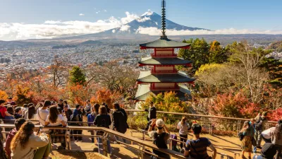 Arakura, Japan - 17 November 2024: People at Chureito Pagoda in autumn with Mount Fuji at background