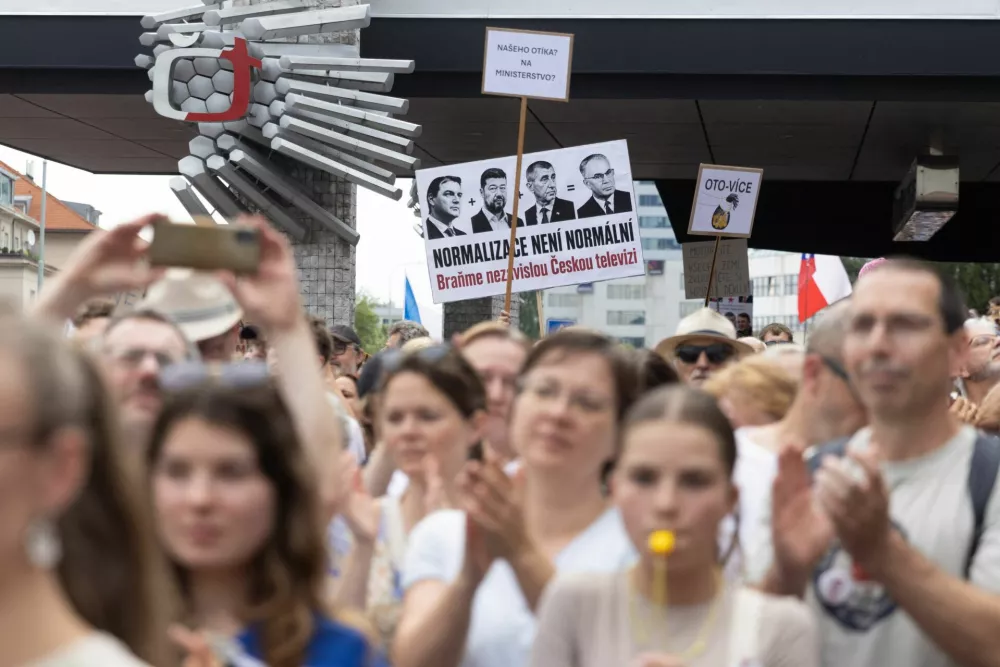 People display a sign reading "Normalization is not normal, let's defend Czech television" during a protest rally in support of public media as the Czech government plans to revamp and cut funding for Czech TV and Czech Radio, in Prague, Czech Republic, June 21, 2026 REUTERS/Eva Korinkova
