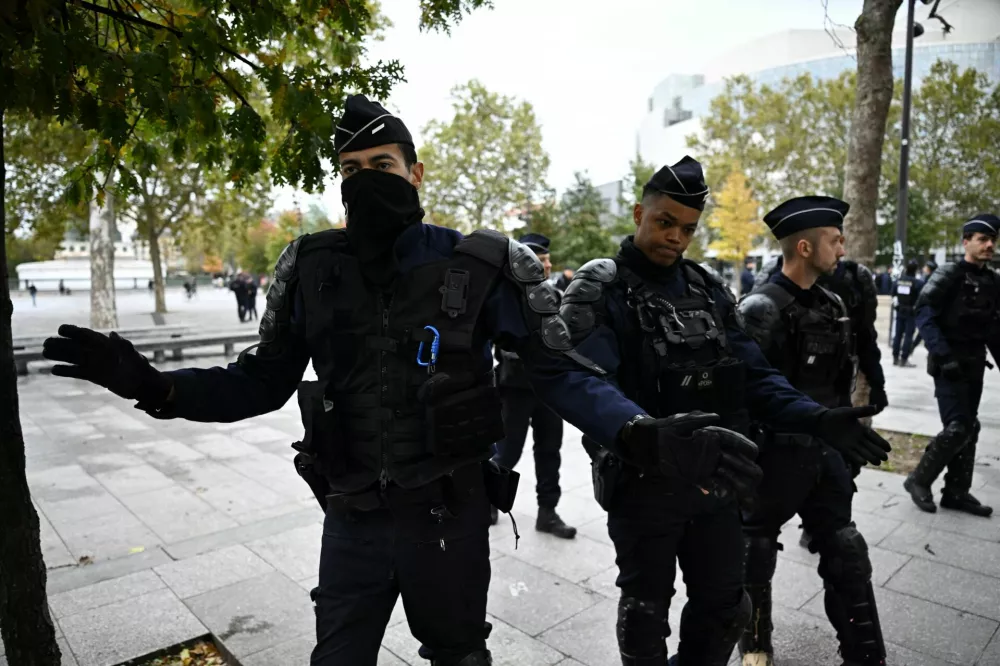 French police move journalists away from the Place de la Bastille in Paris ahead of nationwide protests called by the "Yellow Vests" movement joined by French high school and university students, against the cost of living and rising fuel prices in France, October 24, 2026. REUTERS/Dylan Martinez