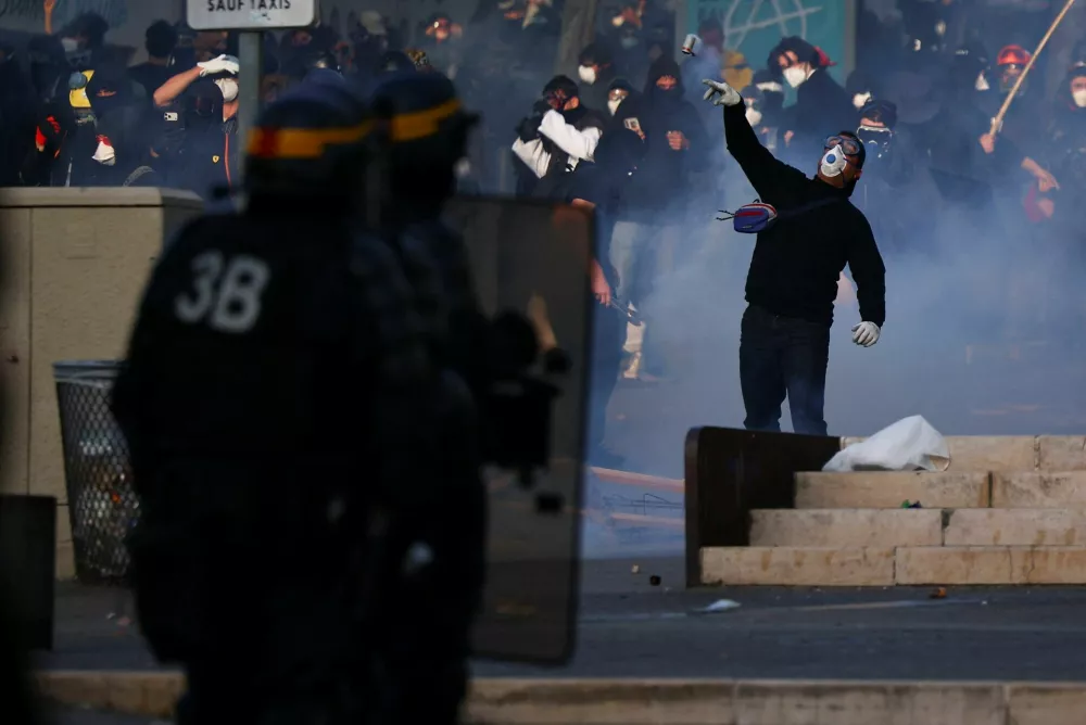 A demonstrator throws a tear gas cannister during an authorised demonstration organised by a labour union in Marseille, France, October 24, 2026, as part of nationwide protests led by the "Yellow Vests" movement and joined by high school and university students. REUTERS/Manon Cruz