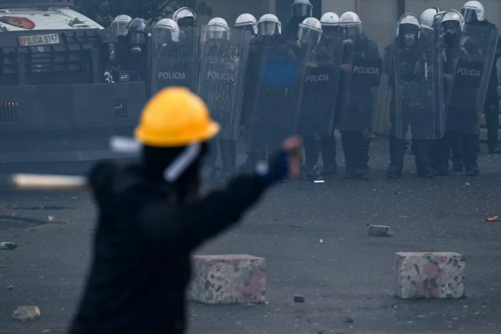Police officers in riot gear stand next to an armoured vehicle during an anti-government protest by students in Tirana, Albania, October 24, 2026. REUTERS/Florion Goga