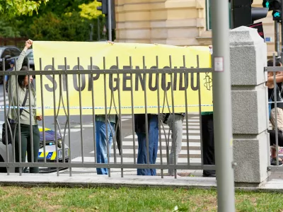 A group of protesters hold a banner outside the Slovenian foreign ministry during a visit of Israel's Foreign Minister Gideon Sa'ar, in Ljubljana, Slovenia, Wednesday, Sept. 9, 2026. (AP Photo/Darko Bandic)