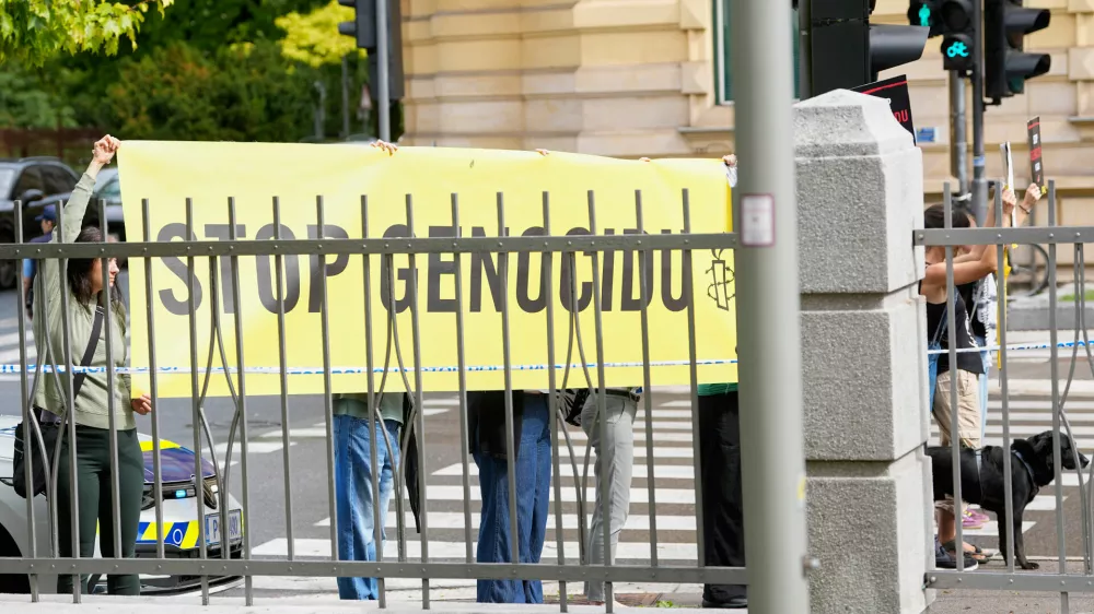 A group of protesters hold a banner outside the Slovenian foreign ministry during a visit of Israel's Foreign Minister Gideon Sa'ar, in Ljubljana, Slovenia, Wednesday, Sept. 9, 2026. (AP Photo/Darko Bandic)