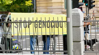 A group of protesters hold a banner outside the Slovenian foreign ministry during a visit of Israel's Foreign Minister Gideon Sa'ar, in Ljubljana, Slovenia, Wednesday, Sept. 9, 2026. (AP Photo/Darko Bandic)