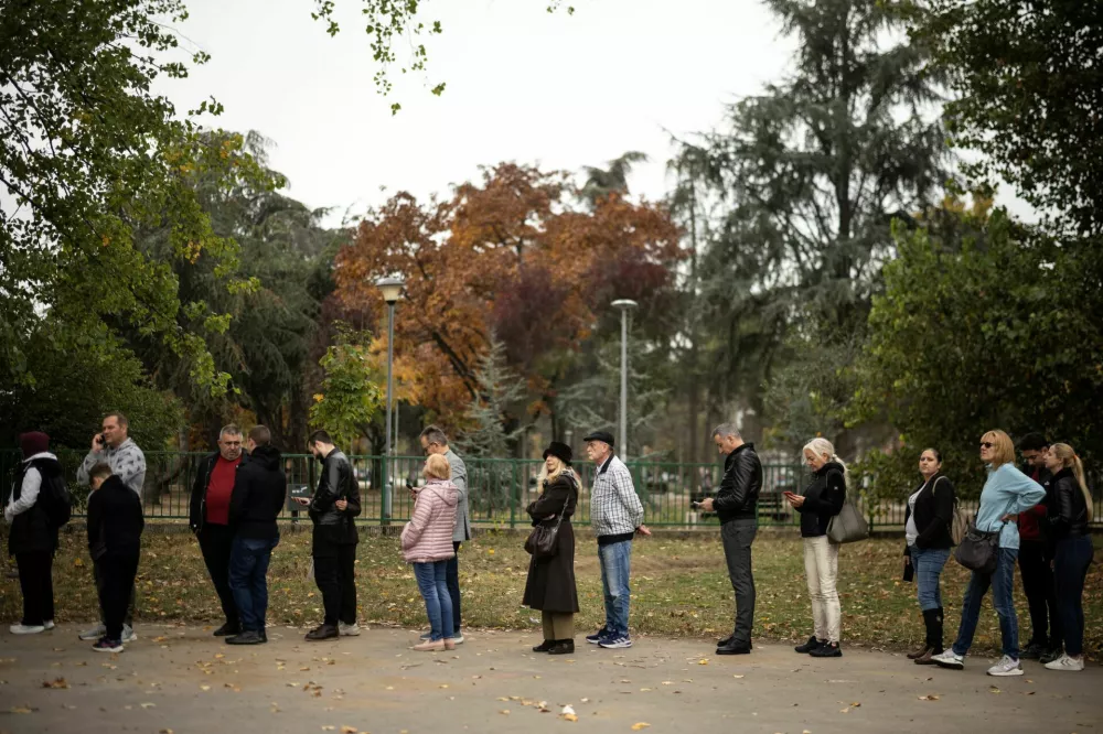 People queue outside a polling station to vote during the parliamentary election in Belgrade, Serbia, October 25, 2026. REUTERS/Marko Djurica