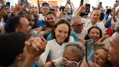 In this photo released by Vente Venezuela Press Office, Venezuelan opposition leader Maria Corina Machado greets supporters at a church in Barquisimeto, Venezuela, Sunday, Oct. 25, 2026. (Vente Venezuela Press Office via AP)