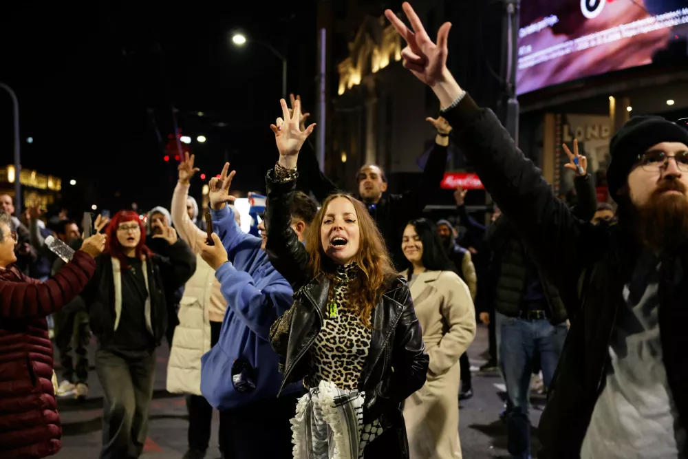 Youngsters cheer after polls closed in the parliamentary election in Belgrade, Serbia, Sunday, Oct. 25, 2026. (AP Photo/Marko Drobnjakovic)