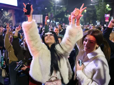 People celebrate after Aleksandar Vucic, leader of the right-wing Serbian Progressive Party (SNS) conceded defeat in the parliamentary election in Belgrade, Serbia, Sunday, Oct. 25, 2026. (AP Photo/Armin Durgut)