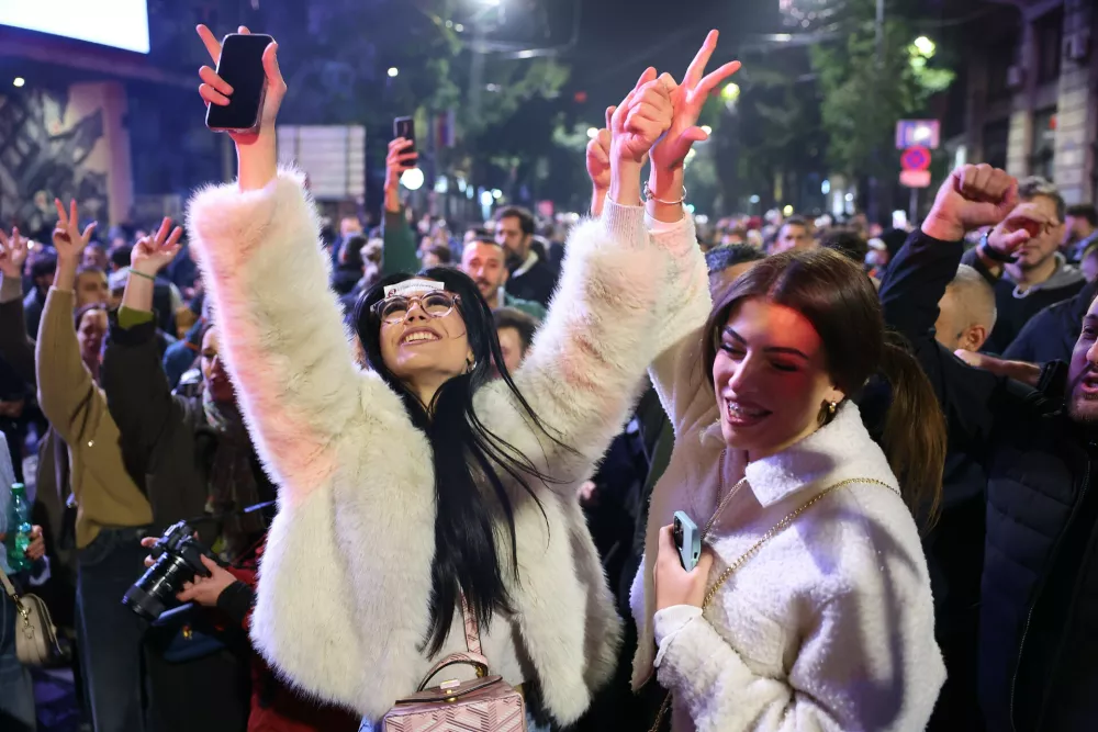 People celebrate after Aleksandar Vucic, leader of the right-wing Serbian Progressive Party (SNS) conceded defeat in the parliamentary election in Belgrade, Serbia, Sunday, Oct. 25, 2026. (AP Photo/Armin Durgut)