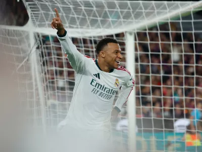 Real Madrid's Kylian Mbappe, right, celebrates after scoring his side's opening goal during a Spanish La Liga soccer match between FC Barcelona and Real Madrid in Barcelona, Spain, Sunday, Oct. 25, 2026. (AP Photo/Joan Monfort)