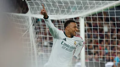 Real Madrid's Kylian Mbappe, right, celebrates after scoring his side's opening goal during a Spanish La Liga soccer match between FC Barcelona and Real Madrid in Barcelona, Spain, Sunday, Oct. 25, 2026. (AP Photo/Joan Monfort)