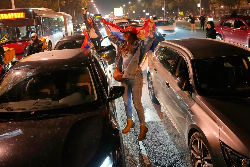People celebrate after Aleksandar Vucic, leader of the right-wing Serbian Progressive Party (SNS) conceded defeat in the parliamentary election in Belgrade, Serbia, Sunday, Oct. 25, 2026. (AP Photo/Darko Vojinovic)