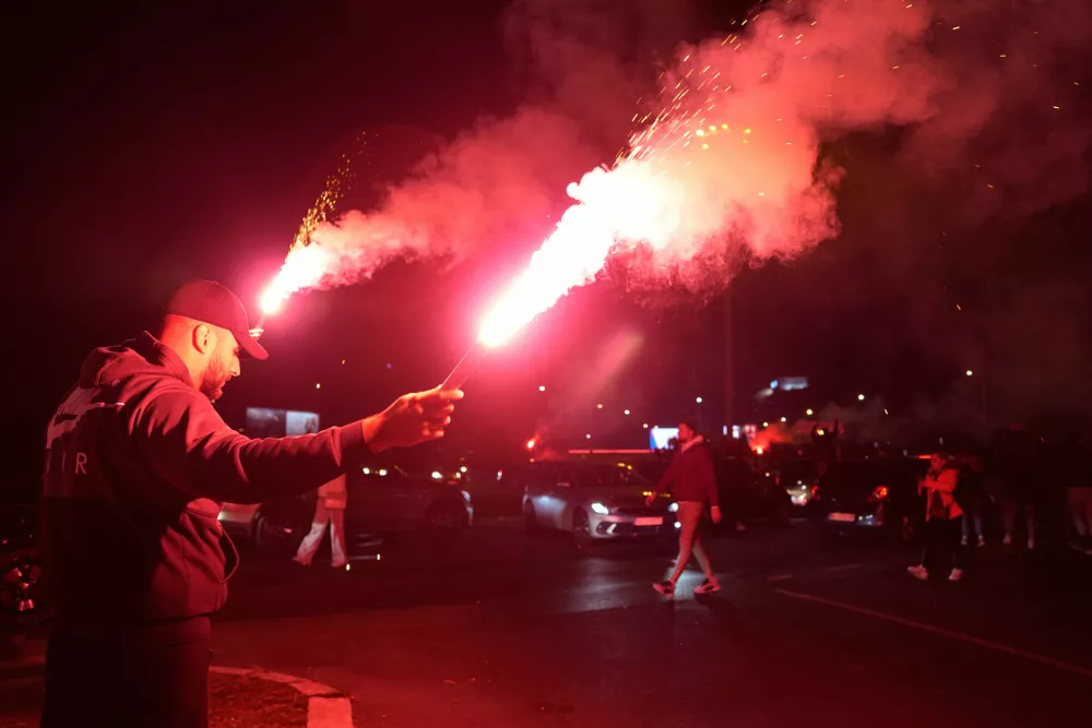 People celebrate after Aleksandar Vucic, leader of the right-wing Serbian Progressive Party (SNS) conceded defeat in the parliamentary election in Belgrade, Serbia, Sunday, Oct. 25, 2026. (AP Photo/Darko Vojinovic)