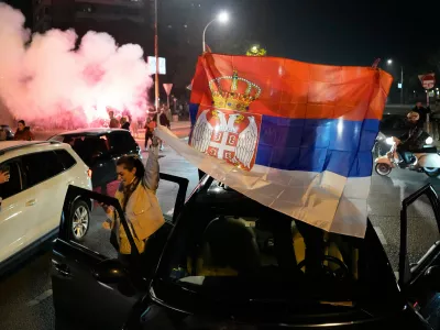 People celebrate after Aleksandar Vucic, leader of the right-wing Serbian Progressive Party (SNS) conceded defeat in the parliamentary election in Belgrade, Serbia, Sunday, Oct. 25, 2026. (AP Photo/Darko Vojinovic)