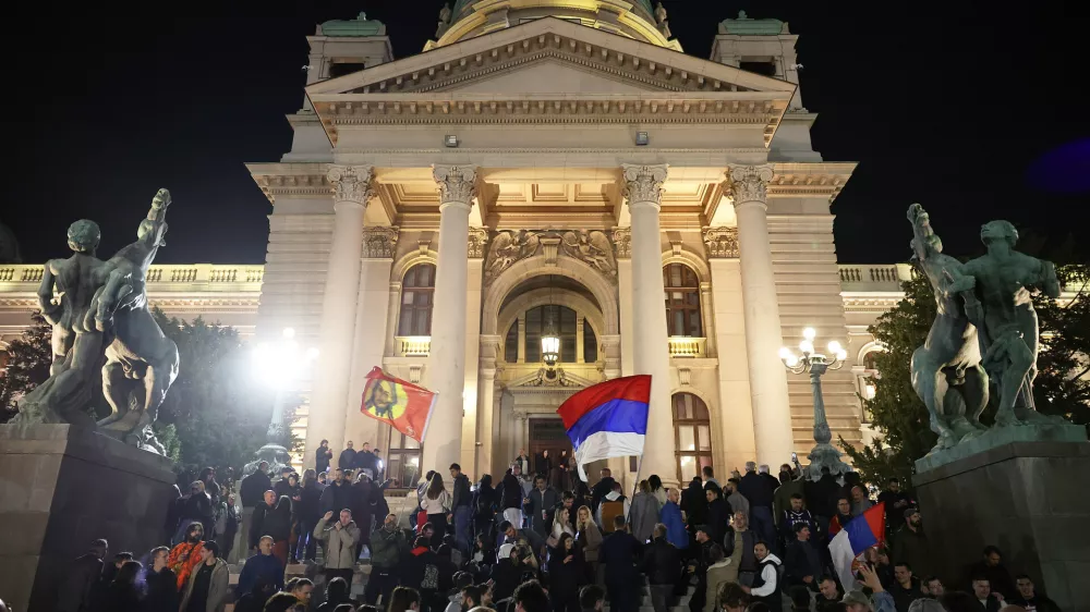 People celebrate outside the parliament after Aleksandar Vucic, leader of the right-wing Serbian Progressive Party (SNS) conceded defeat in the parliamentary election in Belgrade, Serbia, Sunday, Oct. 25, 2026. (AP Photo/Armin Durgut)