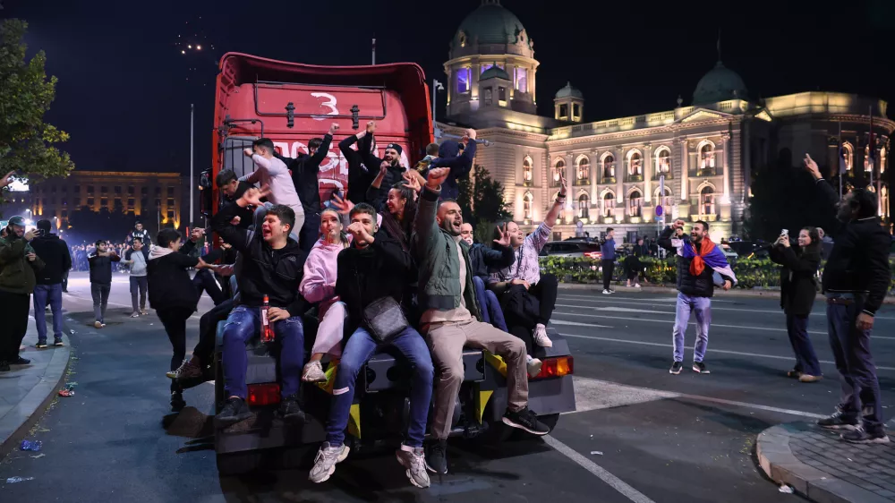 People celebrate outside the National Assembly, after Aleksandar Vucic, leader of the right-wing Serbian Progressive Party (SNS) conceded defeat in the parliamentary election in Belgrade, Serbia, early Monday, Oct. 26, 2026. (AP Photo/Armin Durgut)