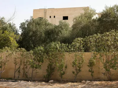 A building shows signs of gunfire at the site where Jordanian security forces arrested three suspects in connection with the deadly church shooting, in the Al-Judayyda area of Karak, Jordan, October 26, 2026. REUTERS/Alaa Al Sukhni