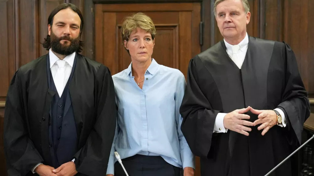 German entrepreneur and gastronome Christina Block and her lawyers Otmar Kury and Ingo Bott wait for the start of her trial at the regional court in Hamburg, Germany, July 11, 2025. Marcus Brandt/Pool via REUTERS