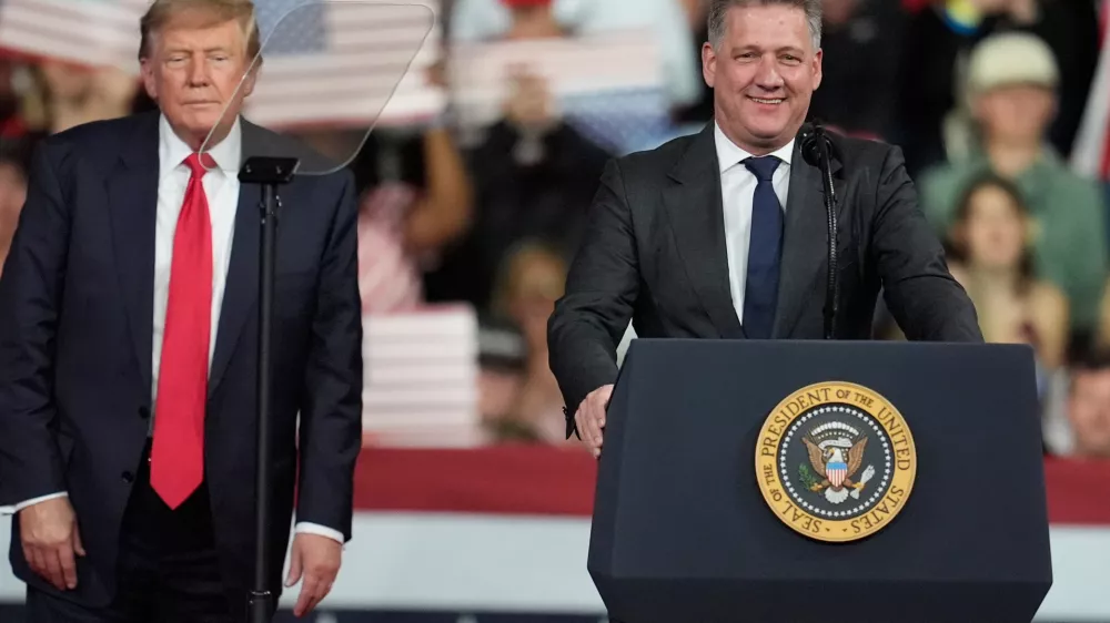 President Donald Trump listens as. Gernot D&ouml;llner, CEO of Audi AG, speaks at a campaign rally at Guardian Centers of Georgia, Saturday, Oct. 24, 2026, in Perry, Ga. (A5P Photo/Mike Stewart)