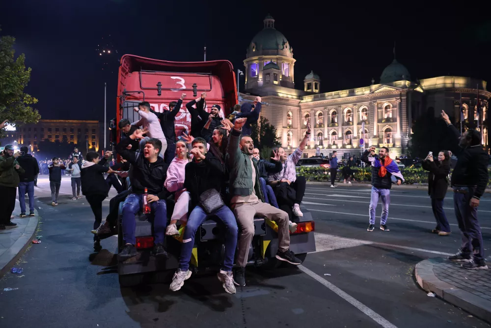 People celebrate outside the National Assembly, after Aleksandar Vucic, leader of the right-wing Serbian Progressive Party (SNS) conceded defeat in the parliamentary election in Belgrade, Serbia, early Monday, Oct. 26, 2026. (AP Photo/Armin Durgut)