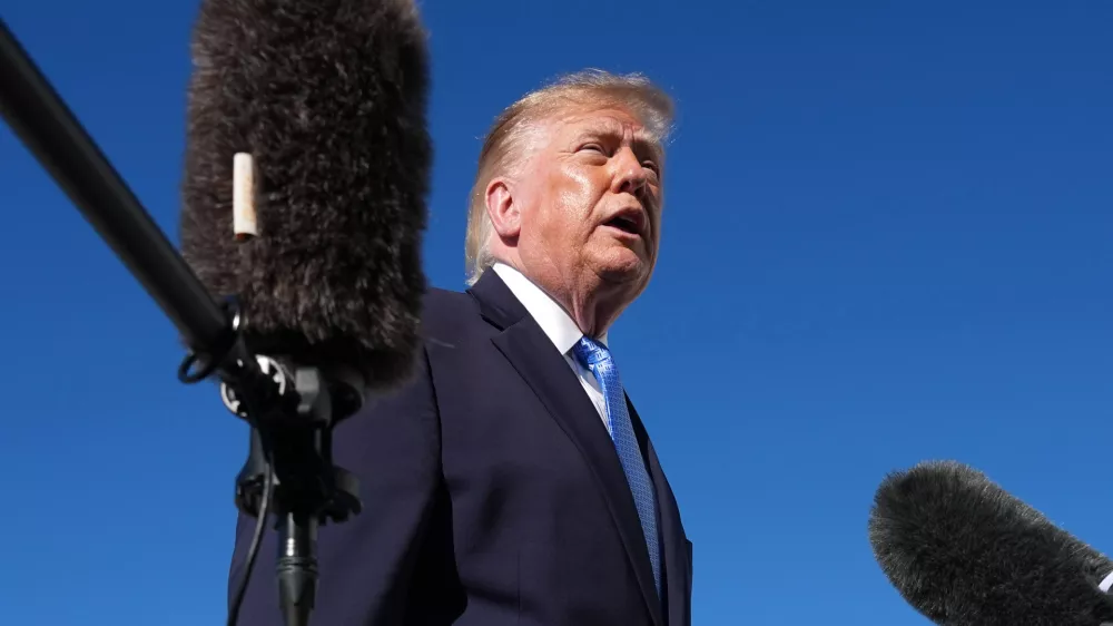 President Donald Trump talks to reporters before boarding Air Force One, at Joint Base Andrews, Md., Monday, Oct. 26, 2026, en route to a campaign rally in Mississippi. (AP Photo/Jacquelyn Martin)